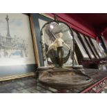 An Art Deco bronze metal mirror - back desk stand with ivory maiden flanked by twin inkwells (a/f)