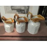 A set of three graduated Victorian pottery jugs
