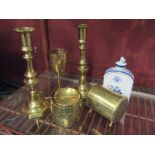 Five pieces of brass ware including a pair of candlesticks,