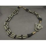 An ethnic African metal and bead tribal necklace with animal head design
