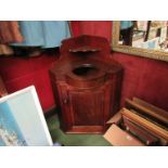 An early Victorian flame mahogany corner washstand,
