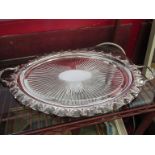 A silver plated oval tray with embossed detail,