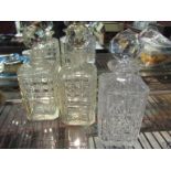 Three crystal and cut glass square form decanters