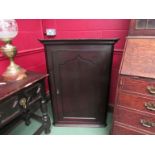 A circa 1830 oak corner cupboard with panelled single door and key,