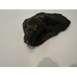 A cast metal swimming dog sculpture