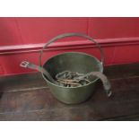 A Victorian brass jam pan containing copper horseshoes and stirrups etc