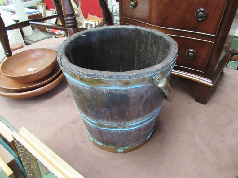 An oak and brass coopered bucket with swing handle,