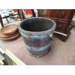 An oak and brass coopered bucket with swing handle,