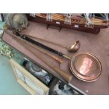 A heavy copper ladle,