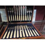 An oak cased silver plate set of fish knives and forks