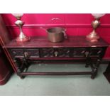 An early 18th Century oak sideboard with three drawers, signs of worm damage,