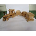 A hand built wooden train constisting of locomotive and three carriages