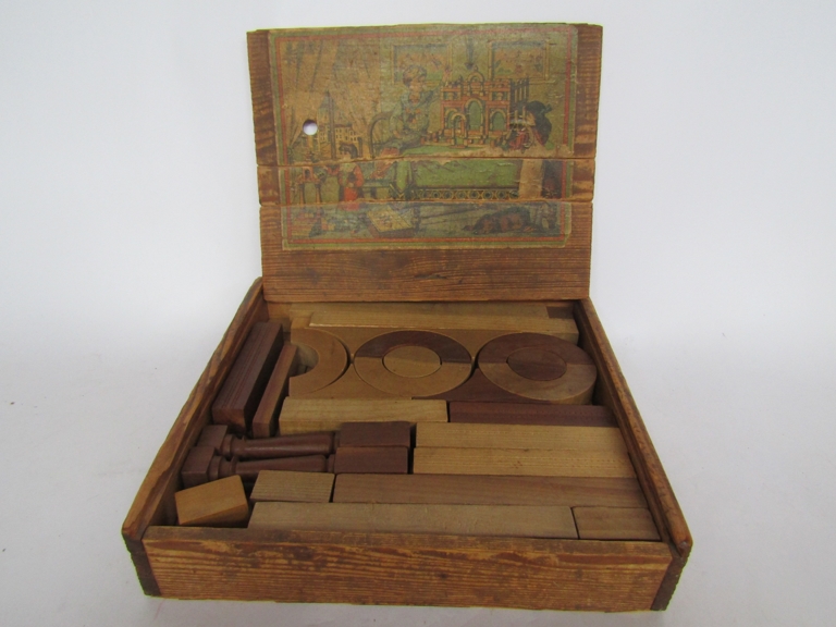 An early 20th Century wooden block set with paper label to box