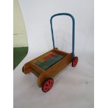 A Tri-ang baby walker and wooden bricks