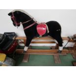 A soft filled rocking horse on oak trestle rocker,