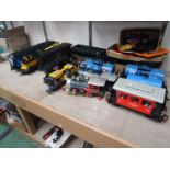 Three battery powered plastic model locomotives and a quantity of mostly G gauge rolling stock and