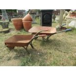 Two child's wheelbarrows