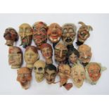 A collection of early 20th Century composition and carved wooden puppet heads