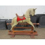 A late Victorian/Edwardian painted wooden bodied rocking horse with horse hair mane and tail with