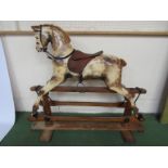 An early 20th Century Lines Bros. rocking horse with dappled painted body on trestle rocker, approx.