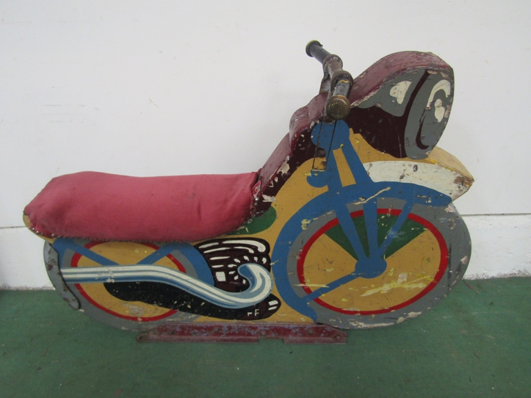 A mid 20th Century painted wooden fairground seat in the form of a motorcycle