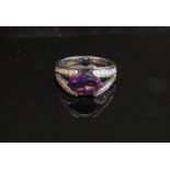 An 18ct white gold amethyst and diamond ring in open shoulder. Size J/K, 4.
