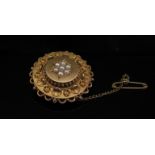 A gold Victorian brooch of circular form set with seed pearls, 3cm diameter, 10.