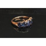 A gold ring set with five graduated sapphires, unmarked. Size L, 3.