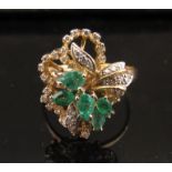 An emerald and diamond cluster ring, marks rubbed. Size T, 4.