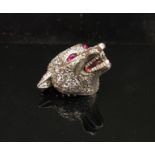 A platinum diamond encrusted brooch as a wolf's head with ruby eyes and enamelled teeth,