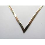 A three tone gold snake link necklace terminating in a V, stamped 375,