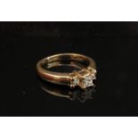 A 14ct gold three stone Princess diamond cut ring. Size N/O, 4.