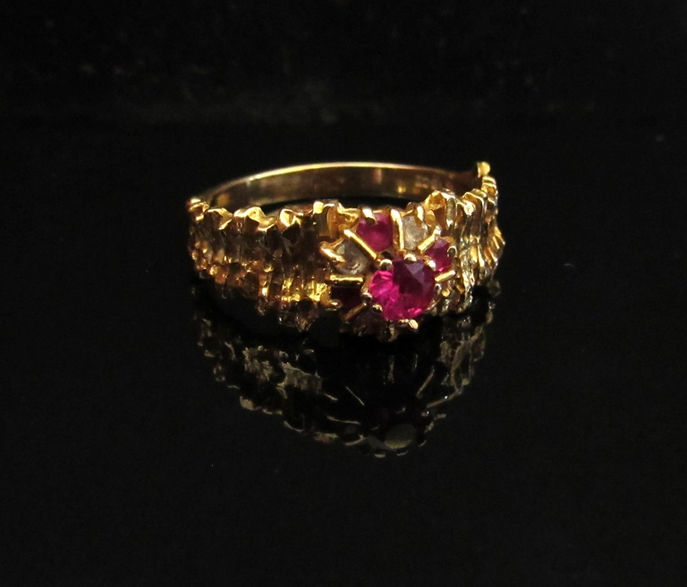 A gold ruby and diamond ring, stamped 18k. Size R, 4.