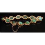 A gold and turquoise bracelet each of the 13 cabochon stones in a rope twist mount, unmarked, 10.