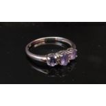 A 9ct white gold three stone tanzanite ring. Size O, 1.