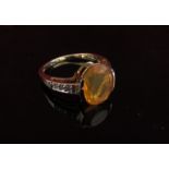 A 9ct gold fire opal and diamond ring. Size O, 2.