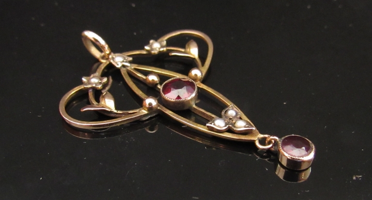 A gold Edwardian pendant set with garnet and pearl, stamped 9ct, 4cm drop, 2.