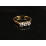 An 18ct gold three stone diamond ring .30ct total approx. Size M/N, 3.