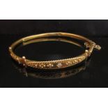 A 15ct gold Victorian stiff hinge bangle set with single diamond to front,