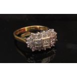 An 18ct gold diamond cluster ring three radiant cut diamonds framed by 14 round cut diamonds.