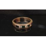 A gold channel set emerald and diamond half eternity ring, unmarked. Size N, 3.