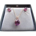A pair of gold alexandrite earrings, unmarked with a matching pendant hung on an 18ct gold chain,