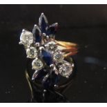 An 18ct gold sapphire and diamond set floral ring setting is 2cm long, .80ct total approx diamonds.