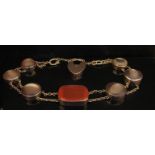 A gold Cornelian and shell panel bracelet with padlock clasp, stamped 9c, 18.