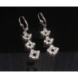 A pair of white gold diamond drop earrings stamped K18, with 375 wires, 4cm drop, 5.