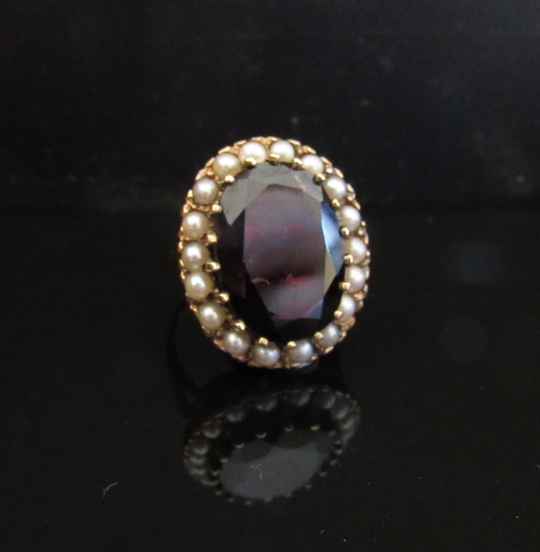 A 9ct gold garnet (18mm x 14mm) and seed pearl ring. Size N, 9.