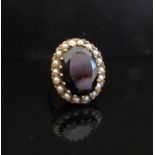 A 9ct gold garnet (18mm x 14mm) and seed pearl ring. Size N, 9.