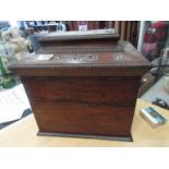 A 19th Century rosewood table cabinet of sarcophagus form, with two large ring side handles,