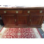 An Edwardian mahogany two drawer over three door long sideboard with brass Art Nouveau style