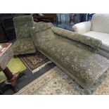 A floral design chaise longue and matching chair with turned feet on castors